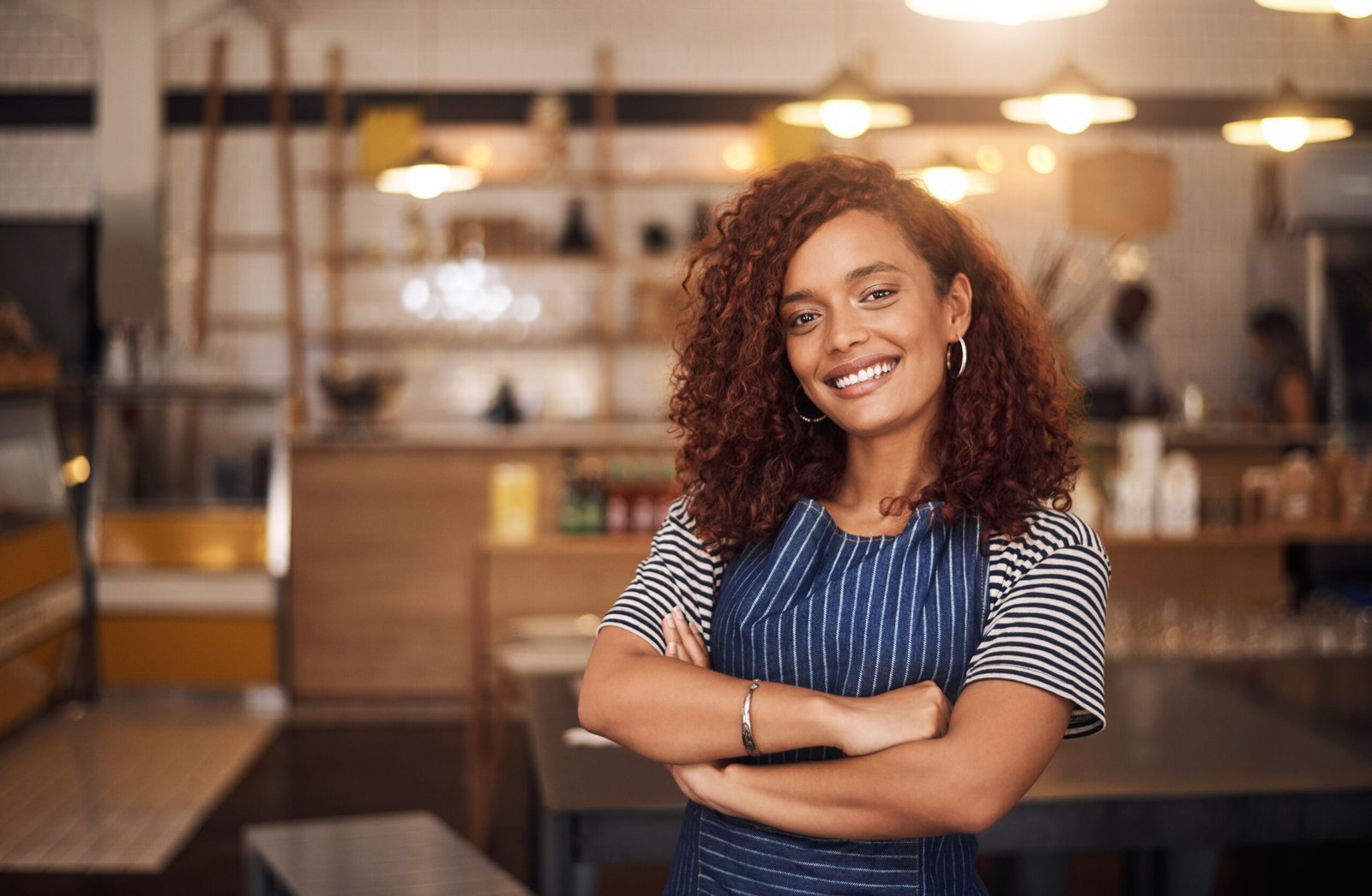 Coffee shop, happy barista and portrait of woman in cafe for service, working and crossed arms. Small business owner, restaurant and professional female waitress smile in cafeteria ready to serve.